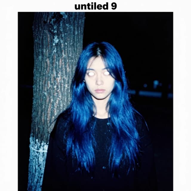 arafed image of a woman standing next to a tree in the dark blue color grading, loosely cropped, , photoscanned, blue long hair, test subject, somber white eyes, 'untitled 9 ', the caretaker, grainy damaged photo