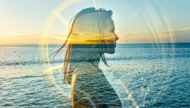 (Double exposure: 1,9). Abstract background (soft colors, marine theme). Seascape (waves, clear water, splashes) inside transparent silhouette of girl's profile. Dissolving colours. Dissolution of textures. Interpenetration of layers and textures. Stylistics: surrealism, realism. Based exclusively on cool colors + yellow sun rays