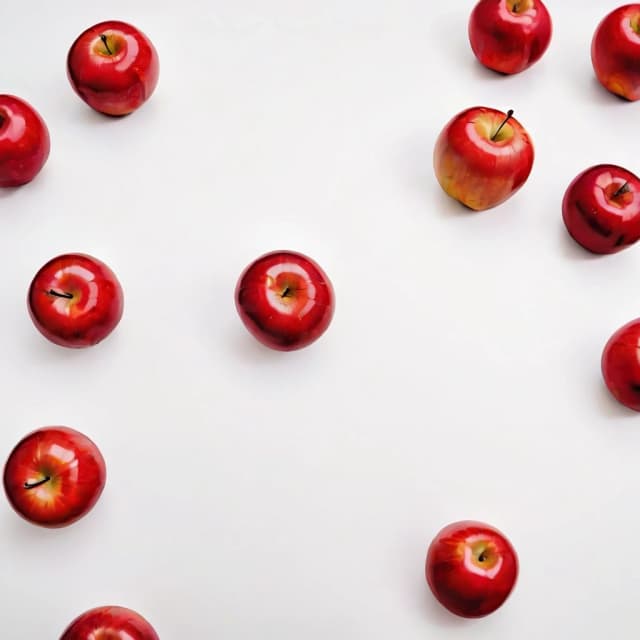 a red apple on a white table