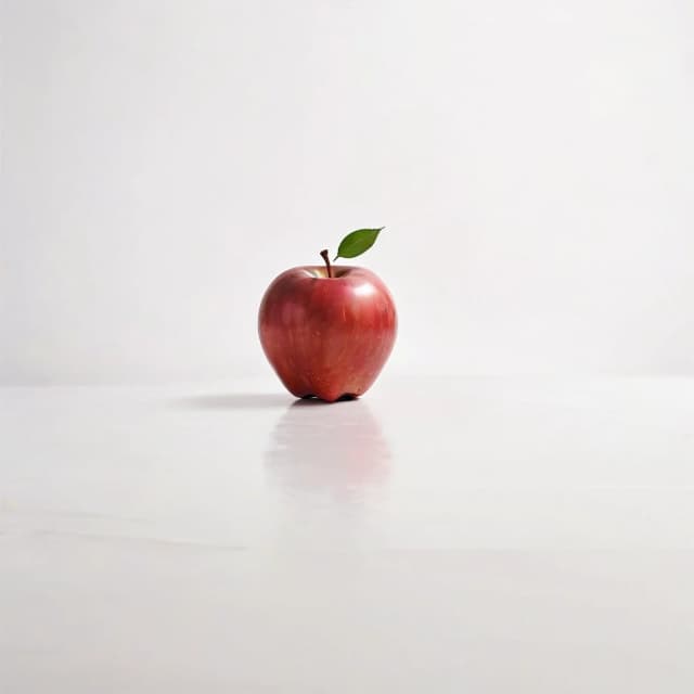 a red apple on a white table